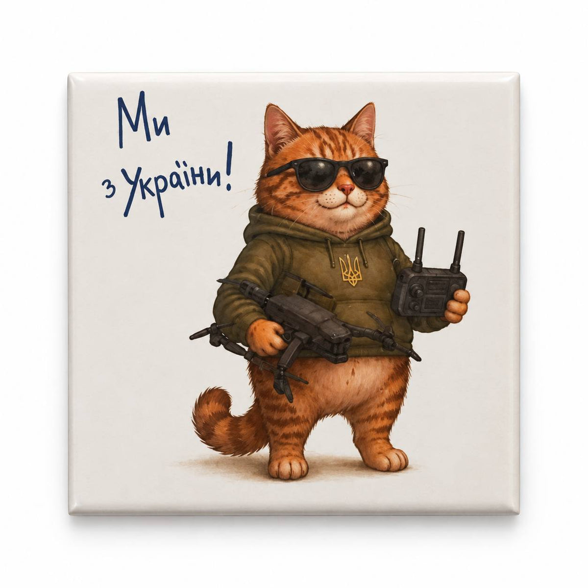 Square magnet with orange cat in khaki trident hoodie holding drone and controller