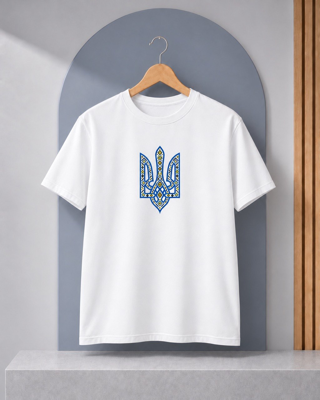 White T-shirt with blue and yellow ornamental trident graphic